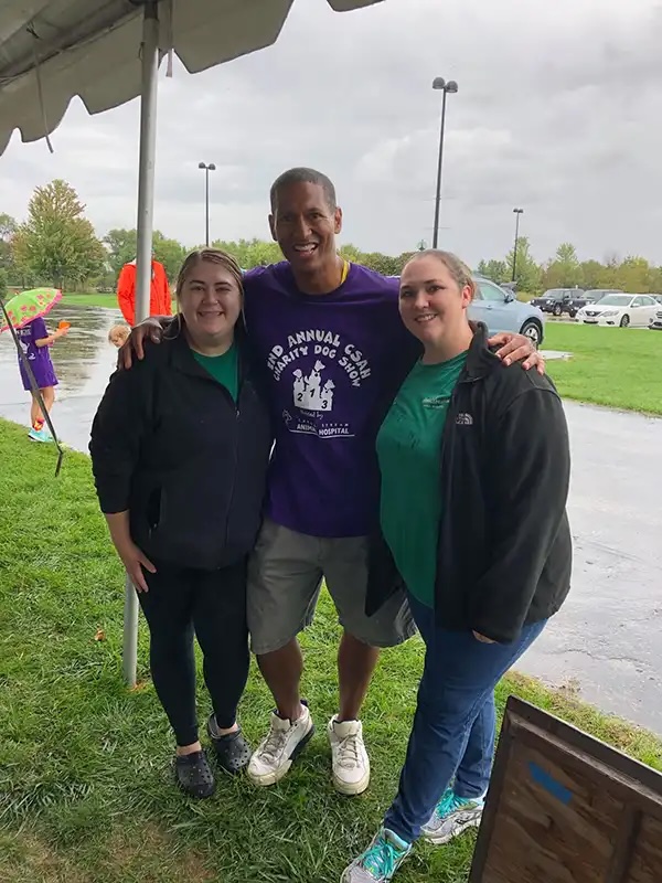 Veterinary staff posing with a community member at the Annual Charity Dog Show in Carol Stream