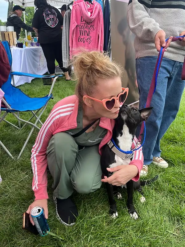 Veterinary technician giving a kiss to a dog at the Annual Charity Dog Show in Carol Stream
